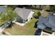 An aerial view showcasing the residence with an attached garage and well-maintained lawn and green backyard at 203 Two Hitch Rd, Goose Creek, SC 29445
