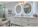 Bright bathroom featuring dual vanity with illuminated mirrors and modern fixtures at 203 Two Hitch Rd, Goose Creek, SC 29445