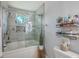 Bathroom with tub-shower combination featuring sleek tile and a glass enclosure at 203 Two Hitch Rd, Goose Creek, SC 29445