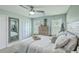 Calm bedroom features neutral tones, a ceiling fan, a large dresser, and two windows with ample natural light at 203 Two Hitch Rd, Goose Creek, SC 29445