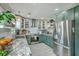 Modern kitchen features white and green cabinets, stainless steel appliances, granite countertops, and ample storage space at 203 Two Hitch Rd, Goose Creek, SC 29445