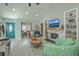 Inviting living room with a stone fireplace, built-in bookshelves, and a teal front door at 203 Two Hitch Rd, Goose Creek, SC 29445