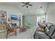 Bright living room featuring a stone fireplace, built-in shelving, and neutral walls, with an adjacent office space at 203 Two Hitch Rd, Goose Creek, SC 29445