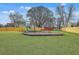 Community playground features a slide, swings and other recreational equipment on a green lawn, great for Gathering fun at 203 Two Hitch Rd, Goose Creek, SC 29445