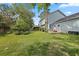 A sprawling backyard with a well-manicured lawn and a view of the two-story home's light blue siding at 205 Lynton Ct, Goose Creek, SC 29445