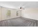 A bright bedroom with carpet, ceiling fan, and natural light streaming through the windows at 205 Lynton Ct, Goose Creek, SC 29445