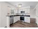 Modern kitchen featuring white cabinets, stainless steel appliances, and sleek black countertops at 205 Lynton Ct, Goose Creek, SC 29445