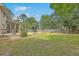 Expansive backyard featuring a pool, patio, and mature trees, perfect for outdoor living and entertaining at 2275 Pristine View Rd, Charleston, SC 29414
