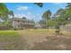 Expansive backyard featuring mature trees, a pool, and ample space for outdoor activities at 2275 Pristine View Rd, Charleston, SC 29414