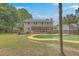 Backyard view showcasing a swimming pool, patio area, and lush landscaping at 2275 Pristine View Rd, Charleston, SC 29414