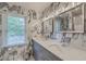 Modern bathroom features double vanity, large mirrors, and sleek gray and white tile at 2275 Pristine View Rd, Charleston, SC 29414