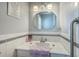 This bathroom features a white countertop sink, decorative mirror, and tile accents, providing a stylish and functional space at 2275 Pristine View Rd, Charleston, SC 29414