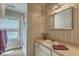 The bathroom is equipped with a vanity, shower, and window, blending functionality with natural light for a refreshing experience at 2275 Pristine View Rd, Charleston, SC 29414
