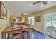 The dining area provides access to an outdoor pool and includes a wooden table, matching chairs, and unique ceiling fan at 2275 Pristine View Rd, Charleston, SC 29414