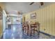 This combined dining and kitchen area features unique tile flooring, white cabinets, and modern appliances at 2275 Pristine View Rd, Charleston, SC 29414
