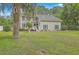 Two-story home with a well-manicured lawn and mature trees at 2275 Pristine View Rd, Charleston, SC 29414