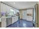 This kitchen boasts stainless steel appliances, white cabinetry, and blue tile flooring for a sleek and modern look at 2275 Pristine View Rd, Charleston, SC 29414