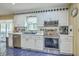 This well-lit kitchen features stainless steel appliances, white cabinets, and an undermount sink, creating a modern space at 2275 Pristine View Rd, Charleston, SC 29414