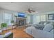 Living room with fireplace, hardwood flooring, and a large sectional at 2275 Pristine View Rd, Charleston, SC 29414