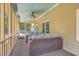 Relaxing screened porch features comfortable wicker seating and ceiling fan at 2275 Pristine View Rd, Charleston, SC 29414