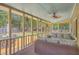 Relaxing screened porch features comfortable wicker seating and a view of the lush backyard at 2275 Pristine View Rd, Charleston, SC 29414