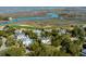 Picturesque aerial view of homes surrounded by lush trees, a golf course, and serene marsh views at 23 Fairway Village Ln, Isle of Palms, SC 29451