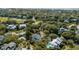 Aerial view of an upscale community, with trees, a golf course, ponds, and luxurious homes at 23 Fairway Village Ln, Isle of Palms, SC 29451