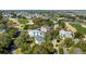 Aerial view of a neighborhood community featuring a golf course, lakes, and many trees at 23 Fairway Village Ln, Isle of Palms, SC 29451