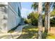 Charming backyard with a landscaped yard, palm trees, and stair access to a porch at 23 Fairway Village Ln, Isle of Palms, SC 29451