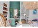 Charming bar area with a mini-fridge, decorative mirror and accents, set against a green accent wall at 23 Fairway Village Ln, Isle of Palms, SC 29451