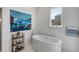 Elegant bathroom featuring a modern freestanding tub, window, and decorative accents at 23 Fairway Village Ln, Isle of Palms, SC 29451