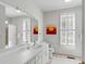 Bright bathroom featuring a large mirror, ample counter space, and stylish fixtures at 23 Fairway Village Ln, Isle of Palms, SC 29451