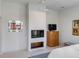 Sleek bedroom featuring a modern fireplace, TV, and white walls at 23 Fairway Village Ln, Isle of Palms, SC 29451