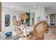 Bright dining room boasts hardwood floors, a decorative light fixture, and unique, stylish wicker chairs at 23 Fairway Village Ln, Isle of Palms, SC 29451