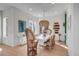 Bright dining room featuring a white table with wicker chairs and decorative light fixture at 23 Fairway Village Ln, Isle of Palms, SC 29451