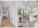 Hallway with hardwood floors, sliding glass doors, and stylish decor, leading to a light-filled space at 23 Fairway Village Ln, Isle of Palms, SC 29451