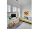 Comfortable home office with modern glass desk, bright windows, and a stylish sofa at 23 Fairway Village Ln, Isle of Palms, SC 29451