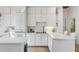 Well-designed kitchen featuring white cabinets, modern appliances, and hardwood flooring at 23 Fairway Village Ln, Isle of Palms, SC 29451