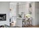 Bright kitchen featuring a breakfast bar, ample white cabinets, and modern appliances at 23 Fairway Village Ln, Isle of Palms, SC 29451