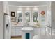 Bright, clean kitchen with white cabinetry, a kitchen island, and a view from the windows at 23 Fairway Village Ln, Isle of Palms, SC 29451