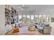 Bright living room with many windows, a unique bookshelf, and hardwood flooring at 23 Fairway Village Ln, Isle of Palms, SC 29451