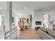 Open-concept living room featuring a fireplace, dining area, and abundant natural light at 23 Fairway Village Ln, Isle of Palms, SC 29451