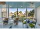 Relaxing screened porch with comfortable seating and views of the beautifully landscaped outdoors at 23 Fairway Village Ln, Isle of Palms, SC 29451