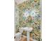 Stylish powder room featuring vibrant tropical wallpaper, pedestal sink, and unique sconce lighting at 23 Fairway Village Ln, Isle of Palms, SC 29451