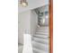 Bright, all-white staircase with natural light from windows near the ceiling at 23 Fairway Village Ln, Isle of Palms, SC 29451