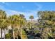 Landscaped community with a golf course, a view of the marsh, and mature palm trees at 23 Fairway Village Ln, Isle of Palms, SC 29451