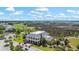 Aerial view of a grand clubhouse surrounded by lush landscaping, a golf course, and marsh views at 2408 Bending Oak Loop, Mount Pleasant, SC 29466