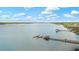 Stunning aerial view of a dock extending into a tranquil waterway with boats and scenic marshland at 2408 Bending Oak Loop, Mount Pleasant, SC 29466