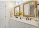 Well-lit bathroom with dual sinks, quartz counters, decorative mirrors, and white cabinets at 2408 Bending Oak Loop, Mount Pleasant, SC 29466