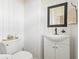 Cozy powder room with white wainscoting, a modern vanity, and a decorative mirror at 2408 Bending Oak Loop, Mount Pleasant, SC 29466